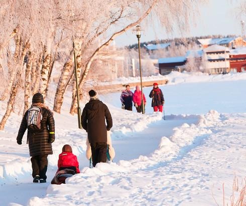 Bild på människor som går längs en gångväg i Luleå på vintern